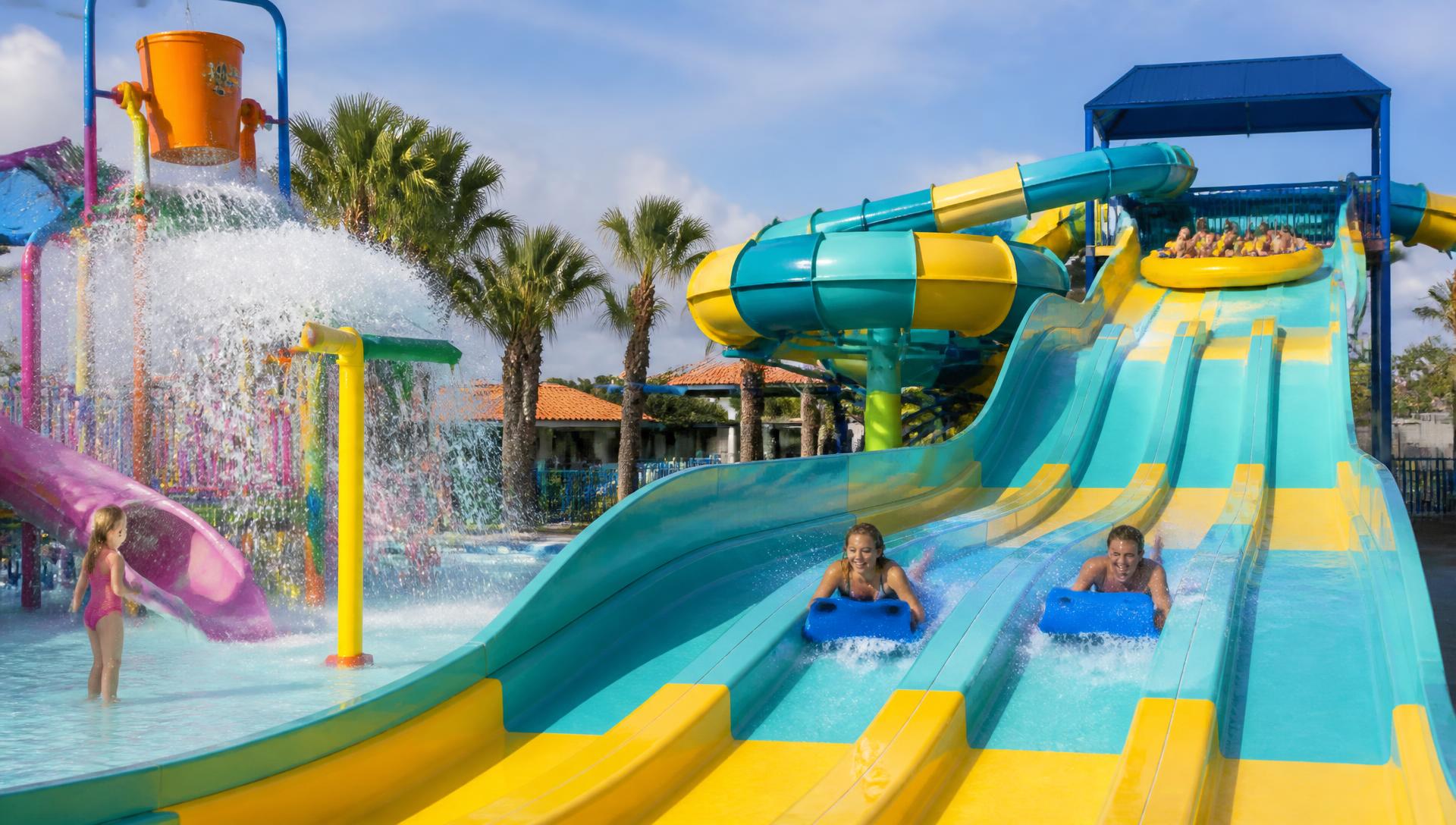 Family raft and multi-lane racer slides with a kids splash pad